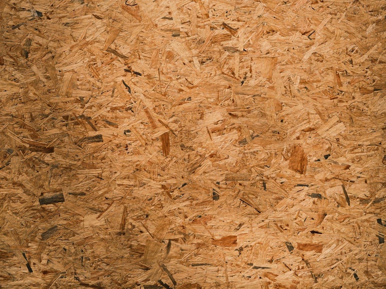 Detailed close-up texture of oriented strand board (OSB) with rich brown tones and intricate patterns.